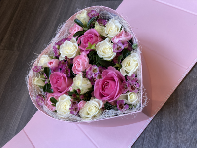 Pink Heart Surprise - This beautifully presented Heart shaped box arrives closed and then open up to reveal a lovely arrangement of fresh flowers. The sides then fold back to angle the box to show of the beautiful arrangement. The standard includes Roses and other seasonal flowers. Pink Heart Surprise - This beautifully presented Heart shaped box arrives closed and then open up to reveal a lovely arrangement of fresh flowers. The sides then fold back to angle the box to show of the beautiful arrangement. The standard includes Roses and other seasonal flowers.