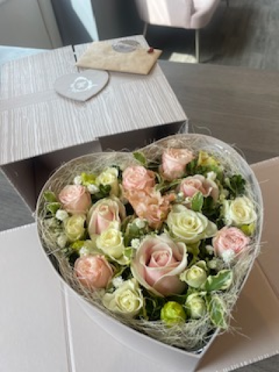 Grey Heart Surprise - This beautifully presented Grey Heart shaped box arrives closed and then open up to reveal a lovely arrangement of fresh flowers. The sides then fold back to angle the box to show of the beautiful arrangement. The standard includes Roses and other seasonal flowers. Grey Heart Surprise - This beautifully presented Grey Heart shaped box arrives closed and then open up to reveal a lovely arrangement of fresh flowers. The sides then fold back to angle the box to show of the beautiful arrangement. The standard includes Roses and other seasonal flowers.