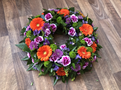 Wreath - Wreath - In Vibrant Colours, including Gerberas, Carnations, Roses and Chrysanthemums.Sizes from 12", 14" & 16" Wreath - Wreath - In Vibrant Colours, including Gerberas, Carnations, Roses and Chrysanthemums.Sizes from 12", 14" & 16"