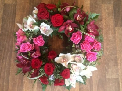 Luxury Wreath - This luxury Wreath has Orchids and Roses with some Beautiful Foliage. Luxury Wreath - This luxury Wreath has Orchids and Roses with some Beautiful Foliage.