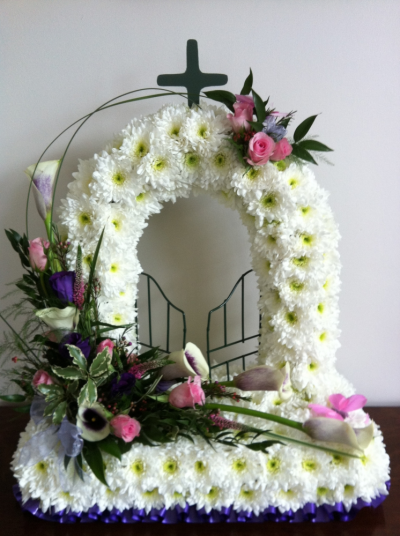 Gates of Heaven - Beautifully made in White Chrysanthemums with a lovely spray of Flowers in Roses and Calla Lilies. Gates of Heaven - Beautifully made in White Chrysanthemums with a lovely spray of Flowers in Roses and Calla Lilies.