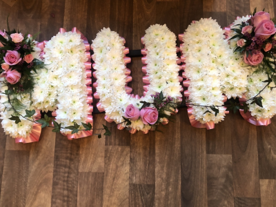 Mum Letters - MUM Letter Tribute with a Pale pink ribbon edge, White Base Flowers and beautiful Pink Rose Sprays Mum Letters - MUM Letter Tribute with a Pale pink ribbon edge, White Base Flowers and beautiful Pink Rose Sprays