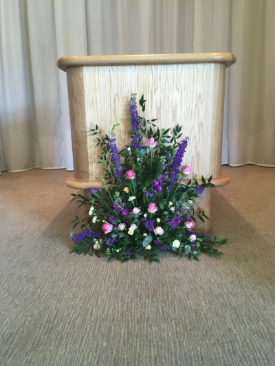 Catafault Arrangement - Made for Cromer Crematorium at the base of the Catafault this narrow thin Seasonal Arrangement sits on the floor and allows the curtain to pass if you wish. Also adding that much needed colour on a sad day. Catafault Arrangement - Made for Cromer Crematorium at the base of the Catafault this narrow thin Seasonal Arrangement sits on the floor and allows the curtain to pass if you wish. Also adding that much needed colour on a sad day.