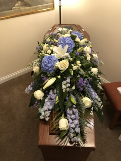 Blue & White Coffin Spray - This unique bespoke Coffin Spray is arranged  using beautiful Blue and White Flowers. It is 5-6ft long Blue & White Coffin Spray - This unique bespoke Coffin Spray is arranged  using beautiful Blue and White Flowers. It is 5-6ft long