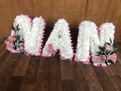 Pink Nan Letters - NAN Letters designed with a Pink Ribbon Edge, White Flower Base and beautiful Pink Rose Sprays Pink Nan Letters - NAN Letters designed with a Pink Ribbon Edge, White Flower Base and beautiful Pink Rose Sprays