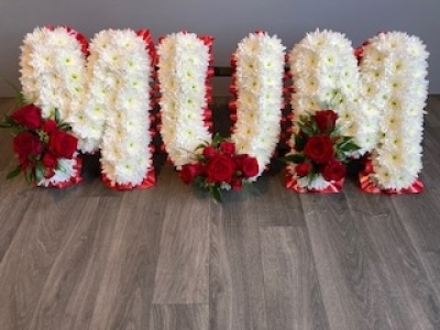 Red Mum - Mum - Arranged with a re ribbon edge, white base flowers and red rose letter sprays Red Mum - Mum - Arranged with a re ribbon edge, white base flowers and red rose letter sprays