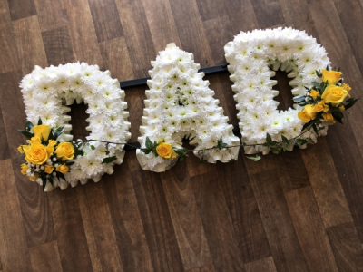 Yellow Dad - DAD Letters with a soft Cream Ribbon Edge, White Base Flowers, finished with Yellow Roses Spray. Yellow Dad - DAD Letters with a soft Cream Ribbon Edge, White Base Flowers, finished with Yellow Roses Spray.