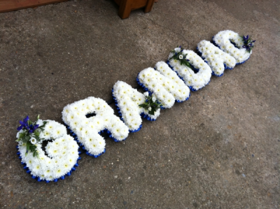 Grandad Letter Tribute - Based in White Chrysanthemums with a Blue Ribbon edge, finished with Blue and White Sprays of Flowers to complete this lovely Tribute. Grandad Letter Tribute - Based in White Chrysanthemums with a Blue Ribbon edge, finished with Blue and White Sprays of Flowers to complete this lovely Tribute.