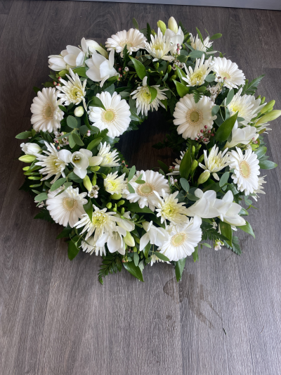 White Wreath - A classic design in all white seasonal flowers White Wreath - A classic design in all white seasonal flowers