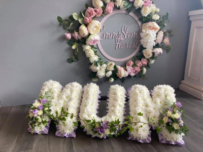 MUM - MUM Letters based in White with a lilac ribbon and flower sprays MUM - MUM Letters based in White with a lilac ribbon and flower sprays