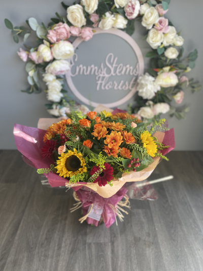 Autumn Glow - Lovely seasonal autumnal colours of flowers and foliage arranged in a hand tied bouquet and presented in water. Autumn Glow - Lovely seasonal autumnal colours of flowers and foliage arranged in a hand tied bouquet and presented in water.